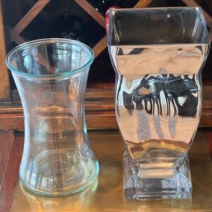 Two vases. One clear glass flower gathering and silver colored  with glass base